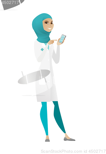 Image of Muslim doctor holding a mobile phone.