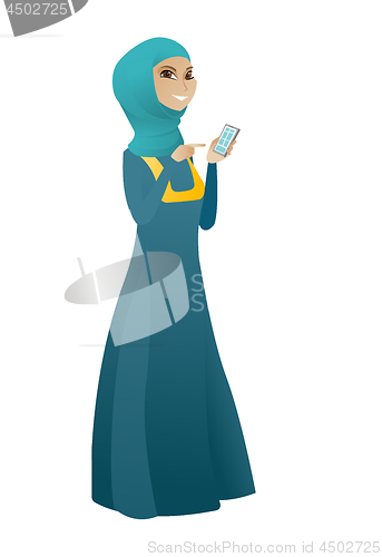 Image of Muslim business woman holding a mobile phone.