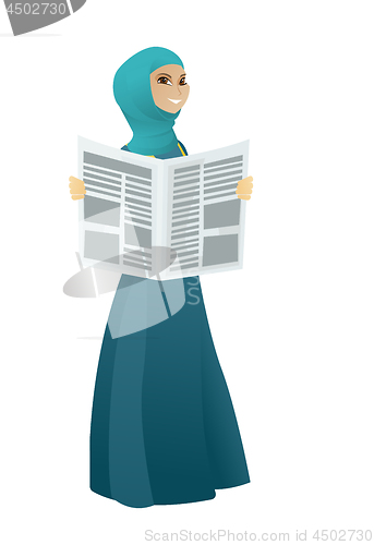 Image of Muslim business woman reading newspaper.