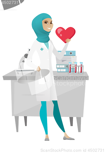 Image of Muslim doctor holding a big red heart.