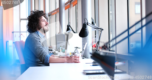 Image of businessman working using a laptop in startup office