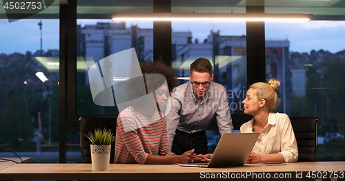 Image of Multiethnic startup business team in night office