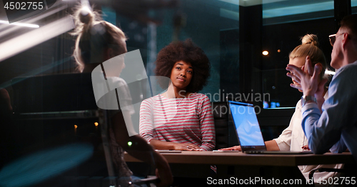 Image of Multiethnic startup business team in night office