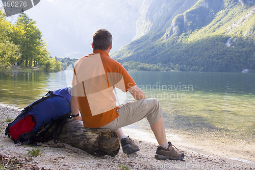 Image of Hiker relaxing at a mountain lake