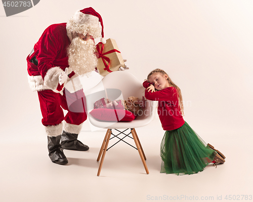 Image of Christmas portrait of cute little newborn baby girl, dressed in christmas clothes, studio shot, winter time