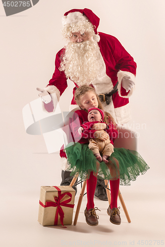 Image of Christmas portrait of cute little newborn baby girl, dressed in christmas clothes, studio shot, winter time