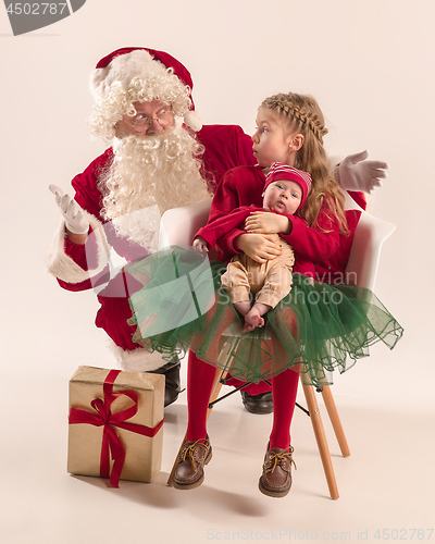 Image of Christmas portrait of cute little newborn baby girl, dressed in christmas clothes, studio shot, winter time