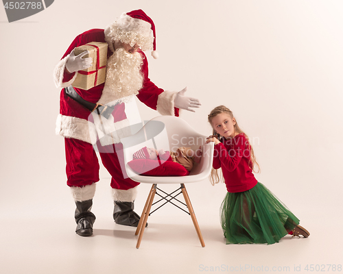 Image of Christmas portrait of cute little newborn baby girl, dressed in christmas clothes, studio shot, winter time