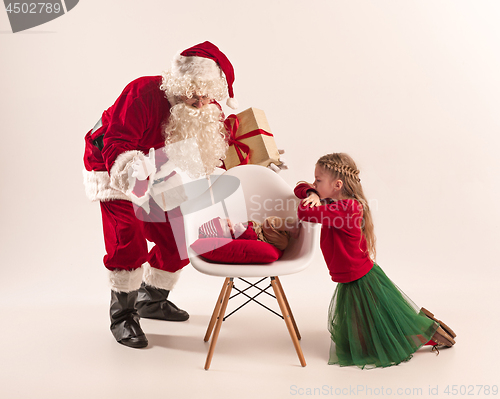 Image of Christmas portrait of cute little newborn baby girl, dressed in christmas clothes, studio shot, winter time