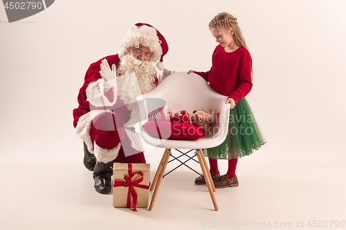 Image of Christmas portrait of cute little newborn baby girl, dressed in christmas clothes, studio shot, winter time