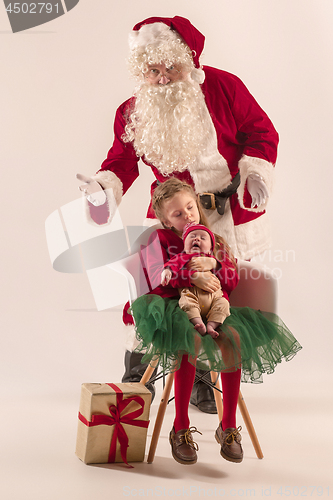 Image of Christmas portrait of cute little newborn baby girl, dressed in christmas clothes, studio shot, winter time