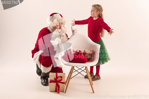 Image of Christmas portrait of cute little newborn baby girl, dressed in christmas clothes, studio shot, winter time