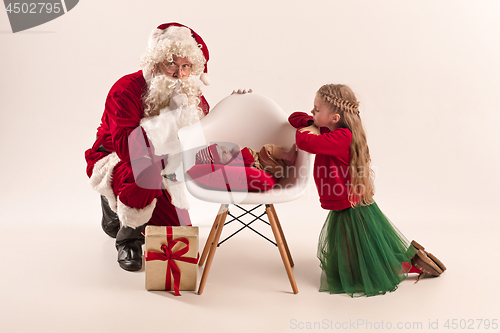 Image of Christmas portrait of cute little newborn baby girl, dressed in christmas clothes, studio shot, winter time