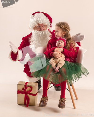 Image of Christmas portrait of cute little newborn baby girl, dressed in christmas clothes, studio shot, winter time