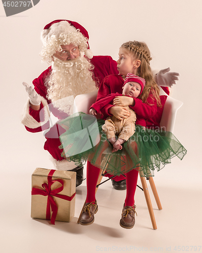 Image of Christmas portrait of cute little newborn baby girl, dressed in christmas clothes, studio shot, winter time