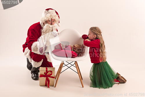 Image of Christmas portrait of cute little newborn baby girl, dressed in christmas clothes, studio shot, winter time