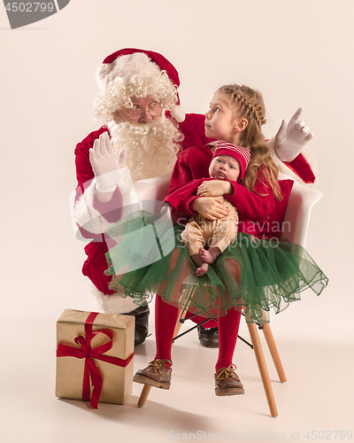 Image of Christmas portrait of cute little newborn baby girl, dressed in christmas clothes, studio shot, winter time