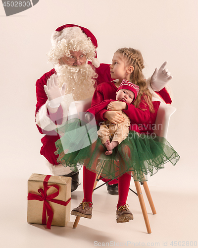 Image of Christmas portrait of cute little newborn baby girl, dressed in christmas clothes, studio shot, winter time