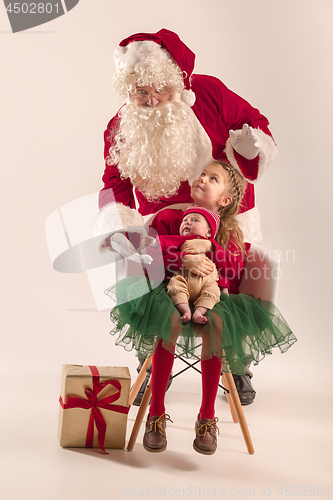 Image of Christmas portrait of cute little newborn baby girl, dressed in christmas clothes, studio shot, winter time