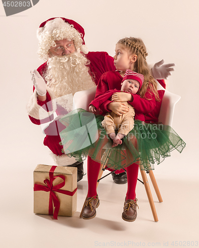 Image of Christmas portrait of cute little newborn baby girl, dressed in christmas clothes, studio shot, winter time