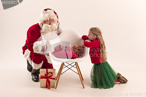 Image of Christmas portrait of cute little newborn baby girl, dressed in christmas clothes, studio shot, winter time