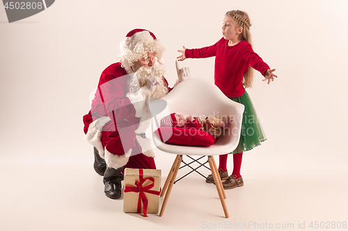 Image of Christmas portrait of cute little newborn baby girl, dressed in christmas clothes, studio shot, winter time