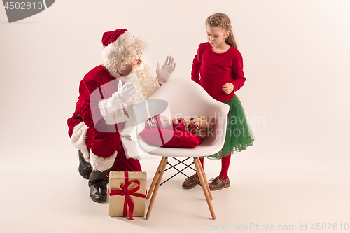 Image of Christmas portrait of cute little newborn baby girl, dressed in christmas clothes, studio shot, winter time