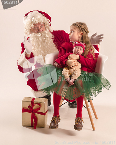 Image of Christmas portrait of cute little newborn baby girl, dressed in christmas clothes, studio shot, winter time