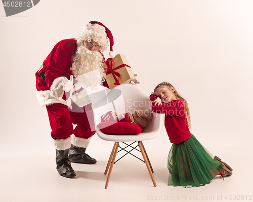 Image of Christmas portrait of cute little newborn baby girl, dressed in christmas clothes, studio shot, winter time