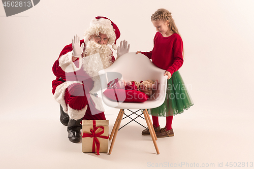 Image of Christmas portrait of cute little newborn baby girl, dressed in christmas clothes, studio shot, winter time