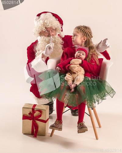 Image of Christmas portrait of cute little newborn baby girl, dressed in christmas clothes, studio shot, winter time