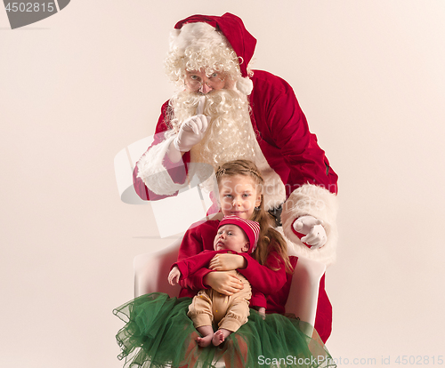 Image of Christmas portrait of cute little newborn baby girl, dressed in christmas clothes, studio shot, winter time