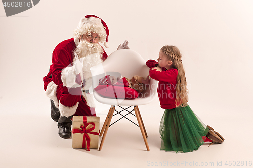 Image of Christmas portrait of cute little newborn baby girl, dressed in christmas clothes, studio shot, winter time