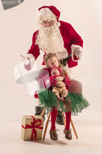 Image of Christmas portrait of cute little newborn baby girl, dressed in christmas clothes, studio shot, winter time