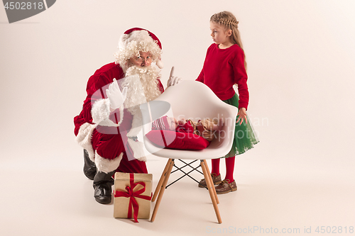 Image of Christmas portrait of cute little newborn baby girl, dressed in christmas clothes, studio shot, winter time