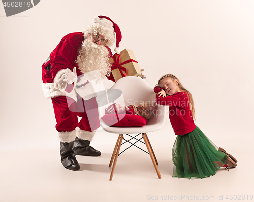 Image of Christmas portrait of cute little newborn baby girl, dressed in christmas clothes, studio shot, winter time