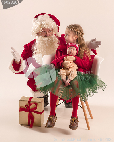 Image of Christmas portrait of cute little newborn baby girl, dressed in christmas clothes, studio shot, winter time