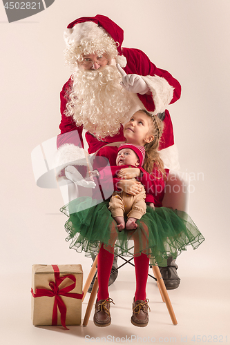 Image of Christmas portrait of cute little newborn baby girl, dressed in christmas clothes, studio shot, winter time