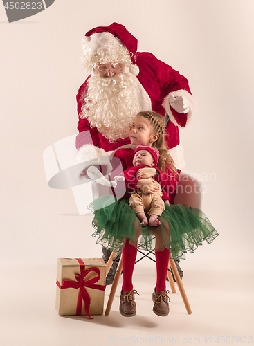 Image of Christmas portrait of cute little newborn baby girl, dressed in christmas clothes, studio shot, winter time