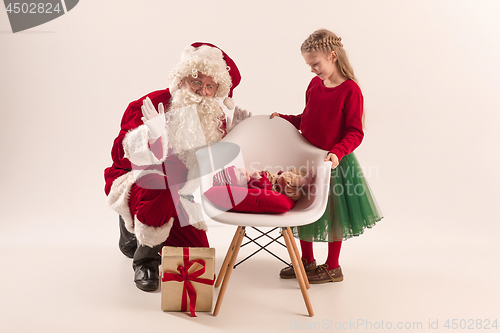 Image of Christmas portrait of cute little newborn baby girl, dressed in christmas clothes, studio shot, winter time