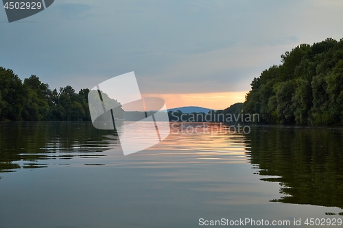 Image of Peaceful waters of a river at sunset