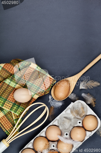 Image of Eggs, kitchen utensil and feathes.