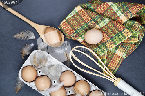 Image of Eggs and feathes on backboard background.