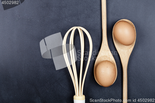 Image of Eggs, wooden spoon and whisker. 