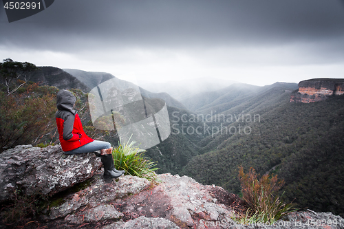 Image of Bushwalker admires winterviews mountain wilderness as fog and cl