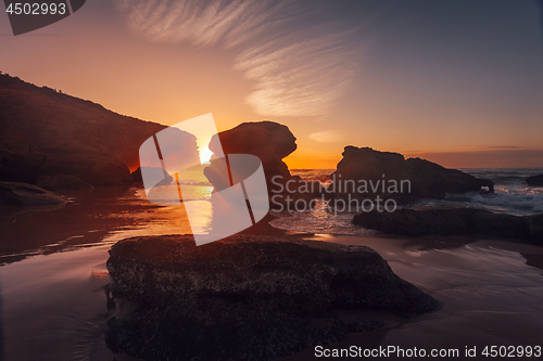 Image of Sun rising behind coastal boulders on the magnificent rocky coastline Australia