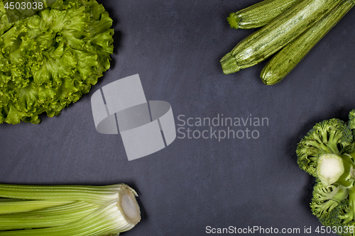 Image of Green organic vegetables on blackboard background.