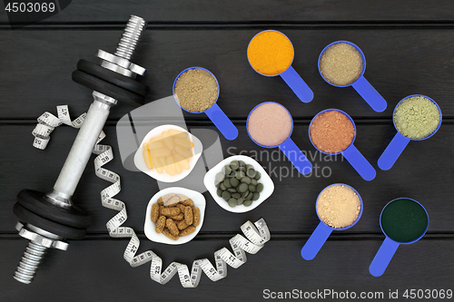 Image of Body Building Food Supplement Powders and Dumbbells 