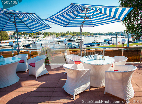 Image of table with armchairs under a sun umbrella