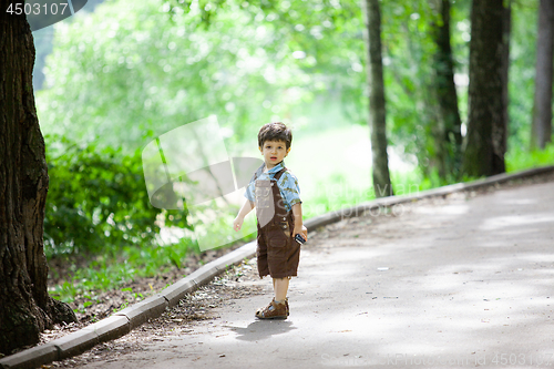 Image of A little boy in an old park